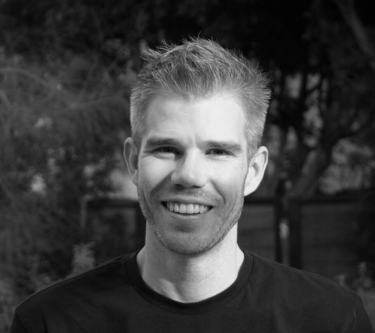 Brian Lee White smiling outdoors